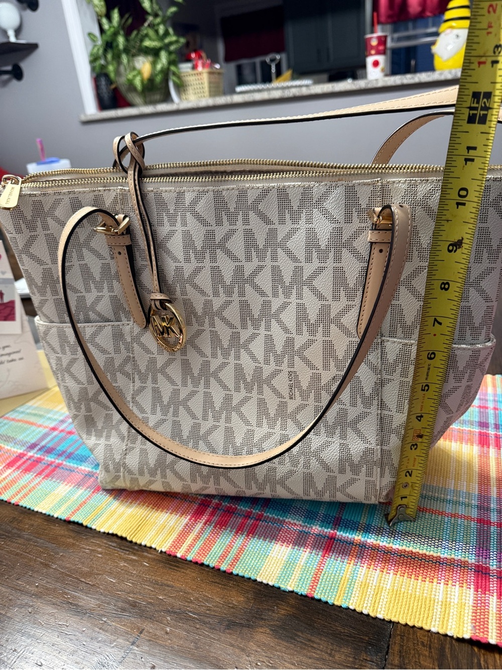 Michael Kors Beige Jet Set Travel Top Zip tote with the signature MK print.